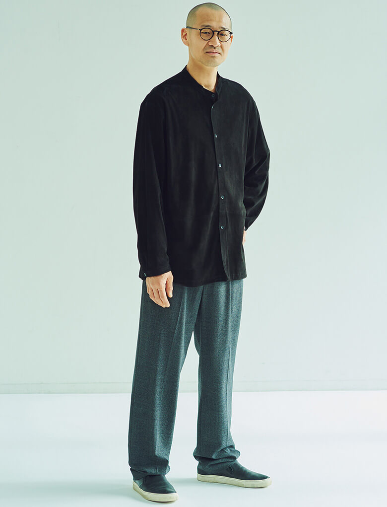 羊革をなめしてサンドペーパーで裏面を起毛させたスエードシャツを、ウールのパンツとシックに合わせている。