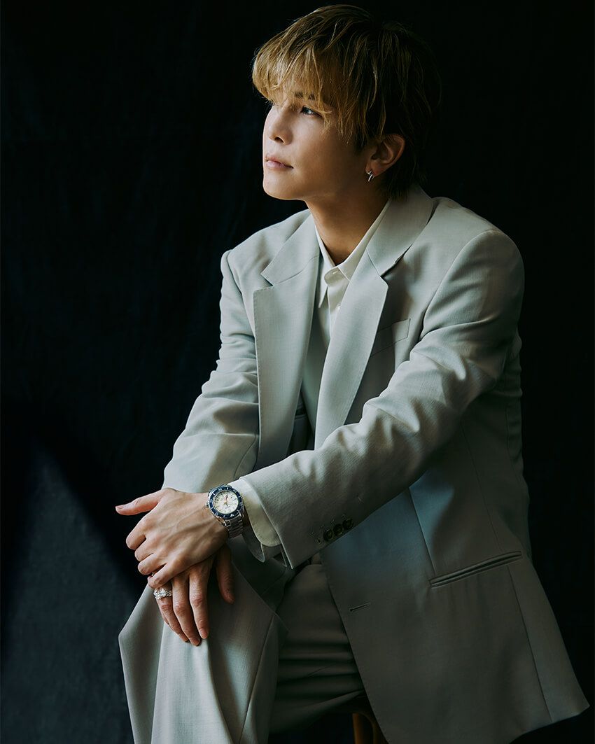 清潔感あるベージュのセットアップで程良くドレスアップ。肩の力を抜いて“着流す”スタイリングに、由緒あるダイバーズウォッチが寄り添う。ホワイトシルバーダイヤルがカラーリンクし、ブルーセラミックスのベゼルは品のいいアクセントになっている。ブレスレットとリングは上を参照。ジャケット13万7500円、シャツ5万9400円、パンツ11万1100円／すべてアミ パリ（アミ パリ ジャパン オンライン　03-4563-9380）、ブレスレット3万3000円、リング各2万3000円／すべてゴッド オンリー ノウズ