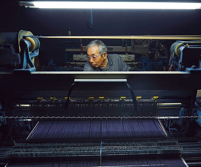 ガシャーン、ガシャーン。けたたましい旧式シャトル織機の音が鳴り響く製織工場。「この機（はた）から悪いものは絶対に出さない」。職人の誇りが、一枚の布に刻みこまれる。